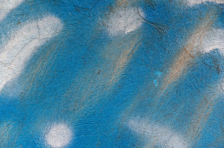 Blue and white painted wall. Texture of the exterior stone wall of the building. Abstract...