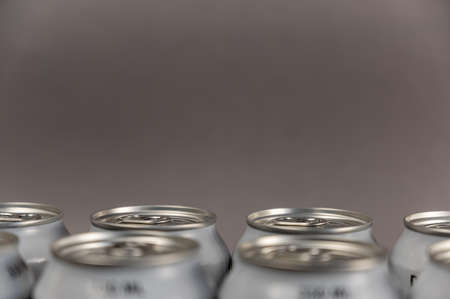 Close-up of 330 ml tin cans. Metallic silver individual beverage containers. back focus. Noise, blur, grain effectの写真素材