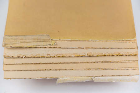 An old tattered book against a neutral background. brown pages. soft cover. Torn text blocks. selective focus.の写真素材