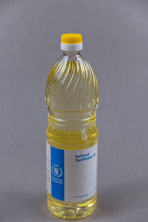A bottle of refined sunflower oil. World Food Program logo on the bottle. Humanitarian aid to residents of Ukraine during the Russian aggression in 2022. Ukraine, Mykolaiv - 06 23 2022.のeditorial素材