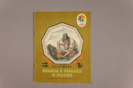 Russian folk tale About the Fisherman and the Fish. A fairy tale by the famous Russian writer and poet Alexander Pushkin. An old book against a gray background. Ukraine, Mykolaiv - 06 23 2022のeditorial素材