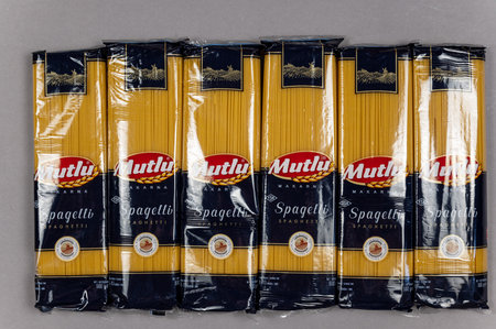 Six packs of spaghetti on grey. Products of the largest Turkish brand Mutlu Makarna. food and grocery products. view from above. Ukraine, Mykolaiv - 06 23 2022.のeditorial素材