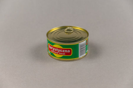 Canned pork against a gray background. Pork stew of the Polish brand Sokolow. The inscription in Polish means TOURISTIC. Ukraine, Mykolaiv - 06 23 2022.のeditorial素材