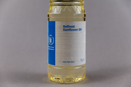 A bottle of refined sunflower oil. World Food Program on the bottle. Humanitarian aid to residents of Ukraine during the Russian aggression in 2022. Ukraine, Mykolaiv - 06 23 2022.のeditorial素材