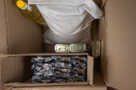 Open donation box with various groceries. top view. selective focus. no people.の写真素材