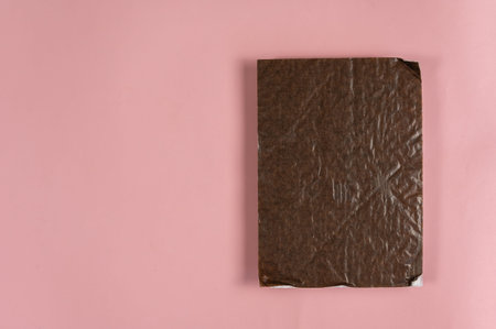 Rectangular piece of brown cardboard against the pink background. Copy space for text and design...