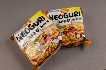 Neoguri Ramyun instant noodles. Colorful plastic packages on grey. Products of Nongshim Co, Ltd. It is the largest South Korean manufacturer of instant food, snacks and drinks. Ukraine, Kiev - 06 22 2022のeditorial素材