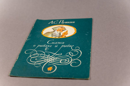 Russian folk tale About the Fisherman and the Fish. A fairy tale by the famous Russian writer and poet Alexander Pushkin. An old book against a gray background. Ukraine, Mykolaiv - 06 23 2022のeditorial素材