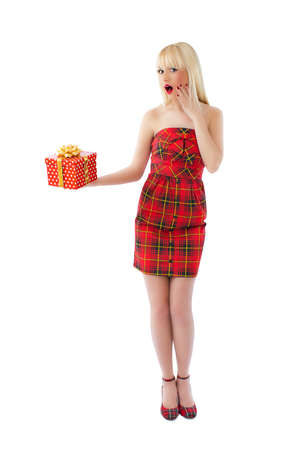 Beautiful young blonde model posing in red dress on white backgroundの写真素材