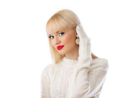 Beautiful woman in white sweater with red lips on white backgroundの写真素材
