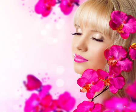 Beautiful blonde young woman with flowersの写真素材