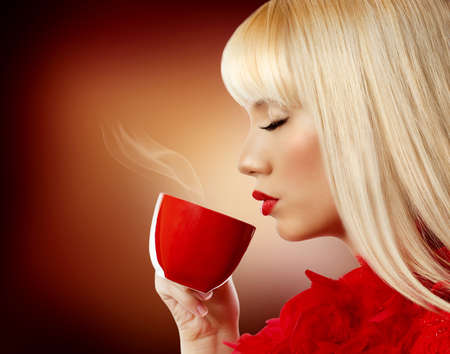 Beautiful woman drinking coffeeの写真素材