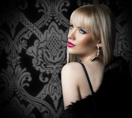 Beautiful blonde woman in luxury fur coat