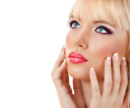 Beautiful blonde woman with manicure and purple makeup on white backgroundの写真素材