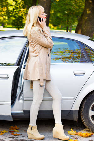 Beautiful blonde woman in autumn parkの写真素材