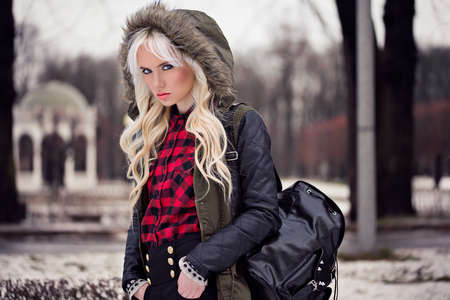 Fashion beautiful woman with backpack outdoorsの写真素材
