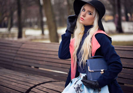 Fashion beautiful woman with bag outdoorsの写真素材