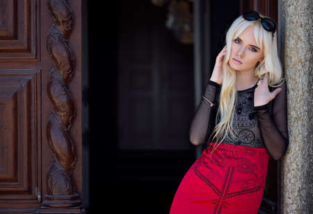 Beautiful blonde young woman in posing outdoorsの写真素材