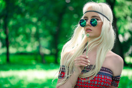 Beautiful girl in sunglasses outdoorsの写真素材