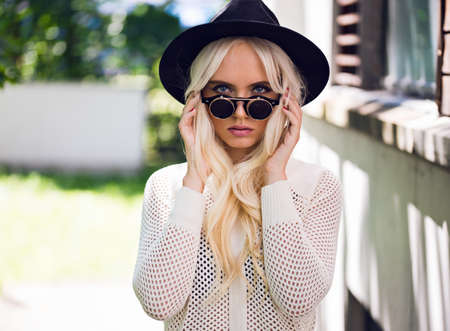Beautiful girl in sunglasses outdoorsの写真素材