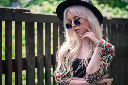 Beautiful girl in sunglasses outdoorsの写真素材