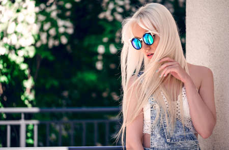 Beautiful girl in sunglasses outdoorsの写真素材