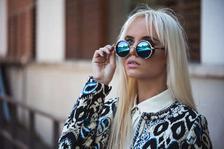Beautiful girl in sunglasses outdoorsの写真素材