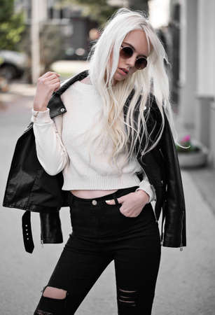Beautiful blonde woman in posing outdoorsの写真素材