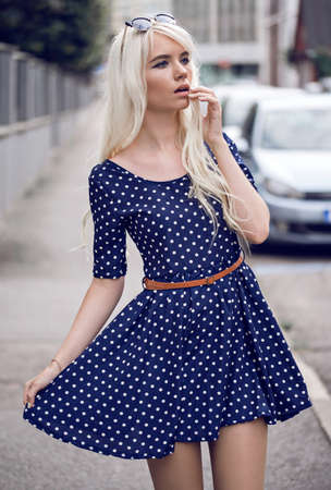 Beautiful blonde woman in posing outdoorsの写真素材
