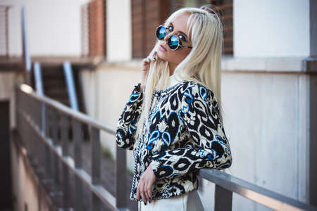 Beautiful blonde woman in posing outdoorsの写真素材