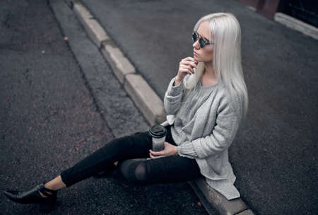 Beautiful blonde model in posing outdoorsの写真素材