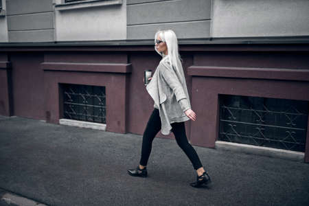 Beautiful blonde woman in posing outdoorsの写真素材