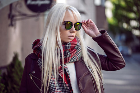 Beautiful blonde girl in sunglassses outdoors