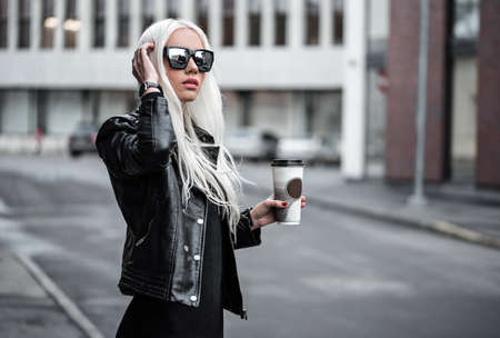Beautiful blonde girl in sunglassses outdoorsの写真素材