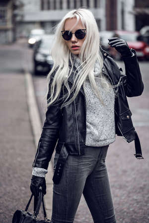 Blonde young woman walking outdoorsの写真素材