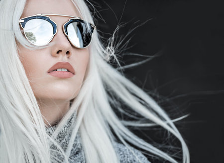 Beautiful blonde girl in sunglassses outdoors