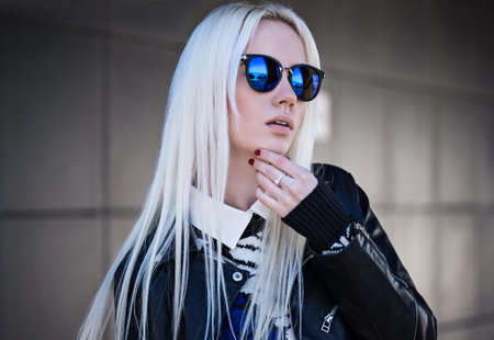 Beautiful blonde girl in sunglassses outdoorsの写真素材