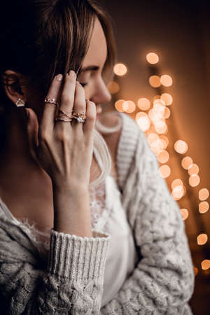 Beautiful girl on golden bokeh lights backgroundの写真素材