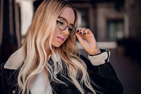 Beautiful blonde girl in sunglassses outdoorの写真素材