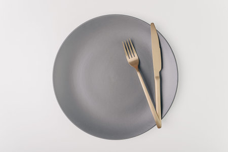 Fork and knife on a empty plate