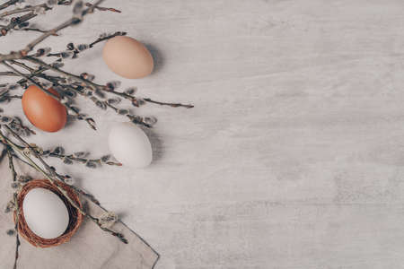 Easter eggs and willow branches on grey backgroundの写真素材