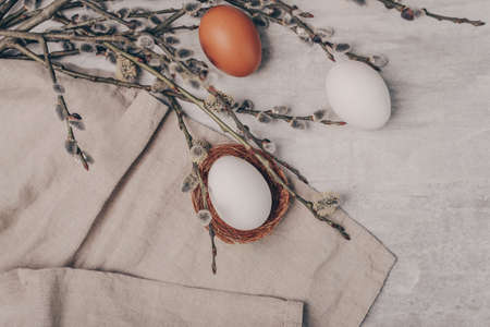 Easter eggs and willow branches on grey backgroundの写真素材
