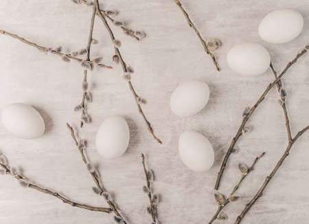 Easter white eggs and willow branches on grey backgroundの写真素材
