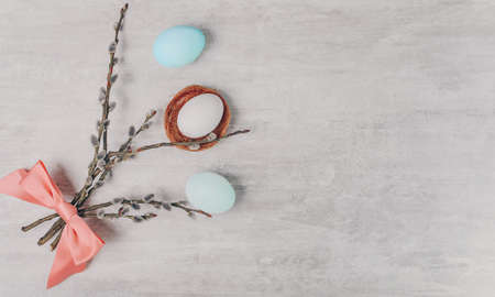 Easter eggs and willow branches on grey backgroundの写真素材