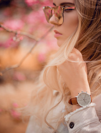 Stylish white watch on woman hand