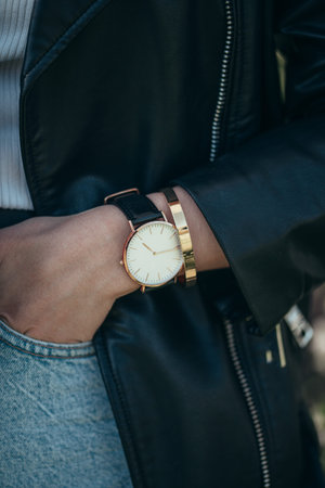 Stylish white watch on woman hand