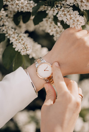 Stylish white watch on woman hand