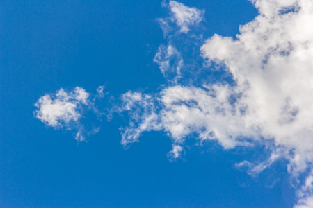 Landscape with blue sky and altocumulus white clouds beautiful blue sky background. Beauty clear cloudy in sunlight calm bright winter or summer windy air background.の写真素材