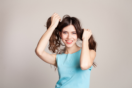girl model smiles and hold her hairの写真素材