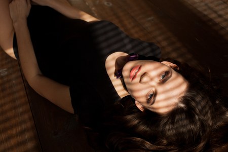 girl model with shadow from the blindsの写真素材